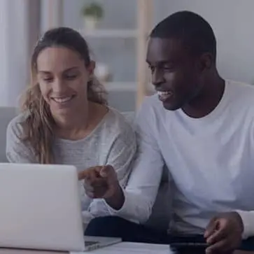 Man and woman sitting in front of a laptop