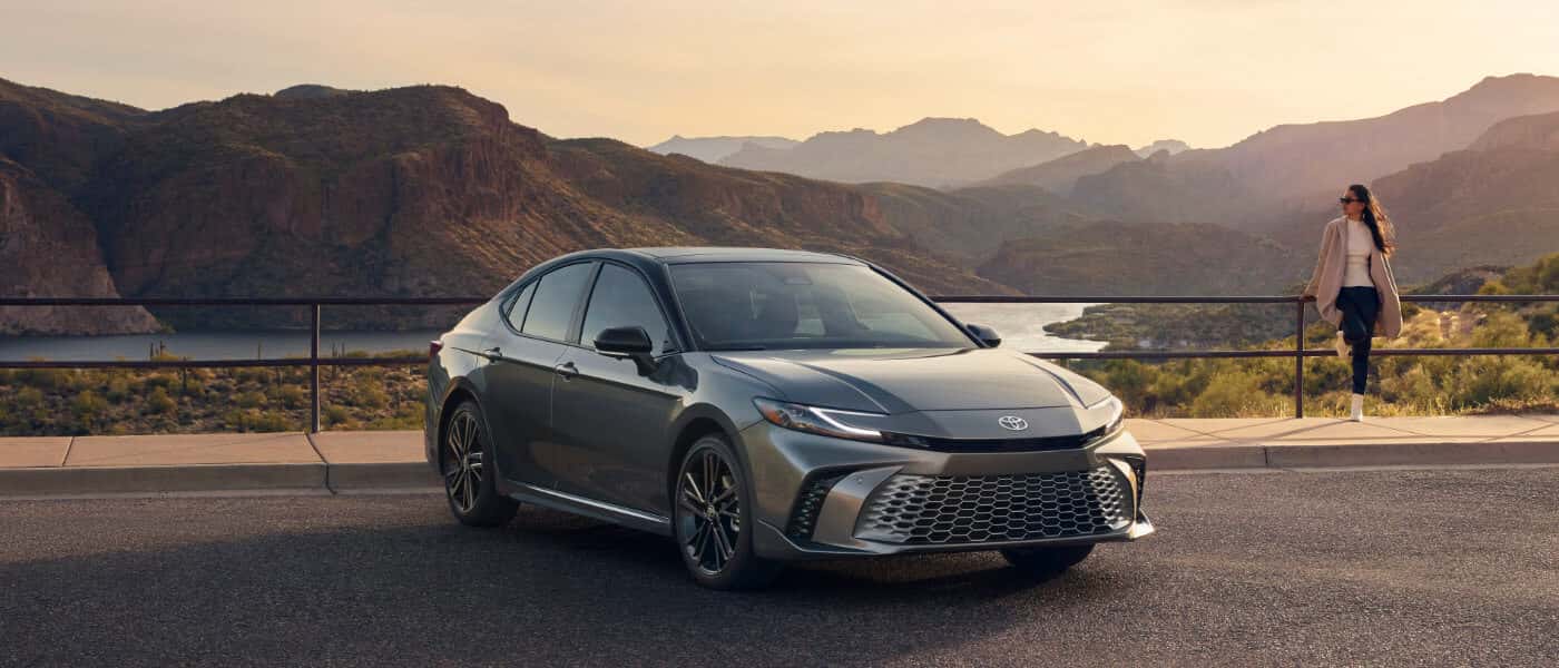 2025 Toyota Camry Exterior Parked In Front Of Scenic Lake