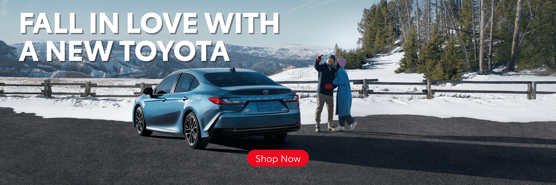 Couple taking a selfie by a Toyota Camry