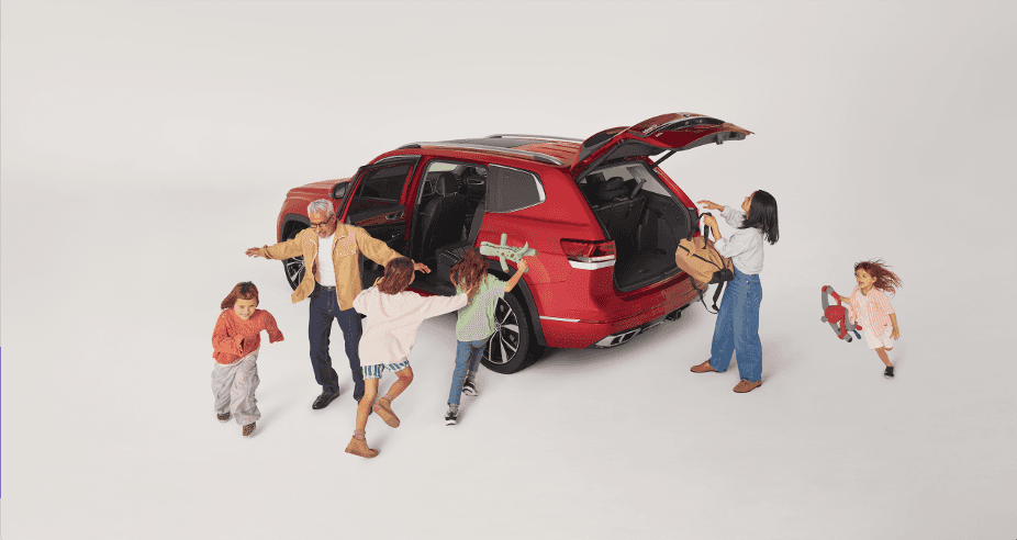 Volkswagen Atlas with trunk open and large family preparing for a trip