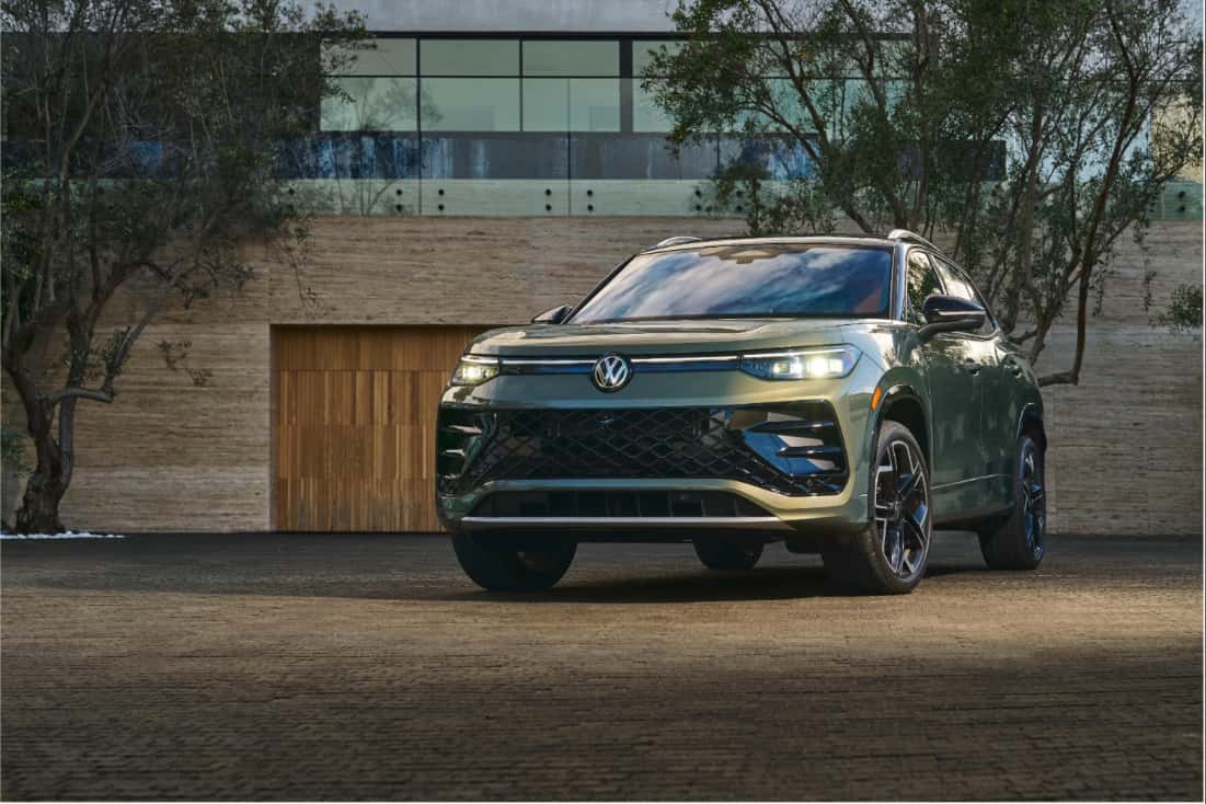 2026 Volkswagen Tiguan SEL R-Line Turbo 4MOTION parked in front of a modern home at dusk