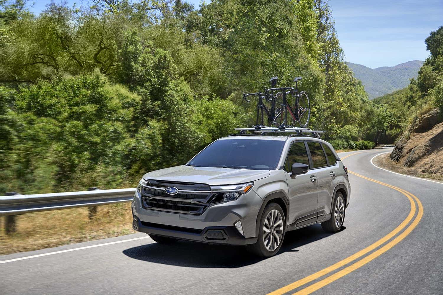 2025 Subaru Forester driving down the street
