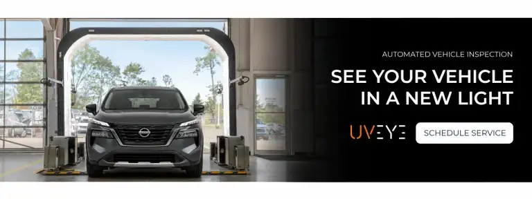 Nissan Rogue driving through the UVeye automated vehicle inspection scanner at Universal Nissan service center in Orlando FL
