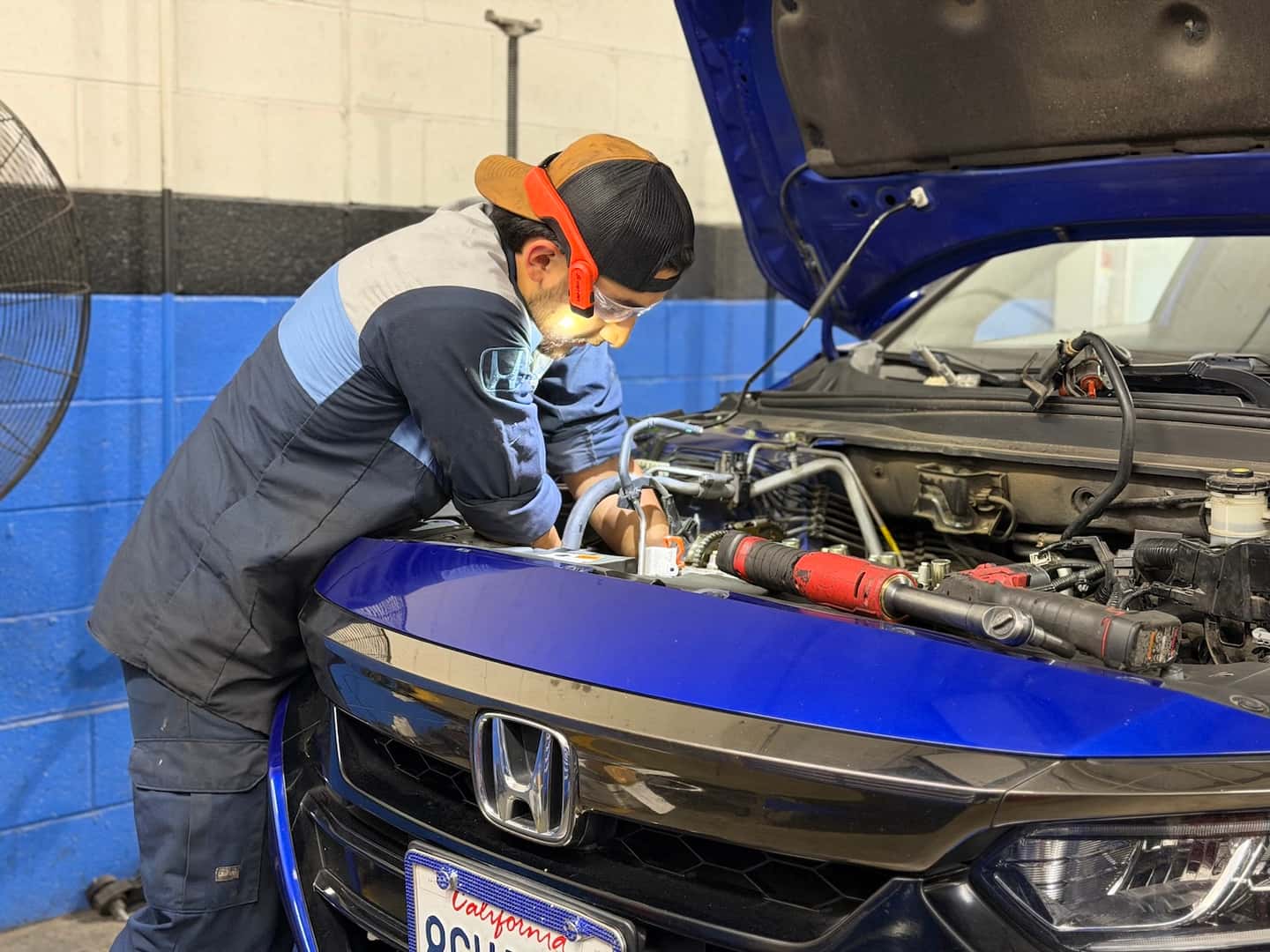 Valley Hi Honda technician inspecting a used Honda in the service department