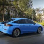 2027 honda civic hatchback driving on road