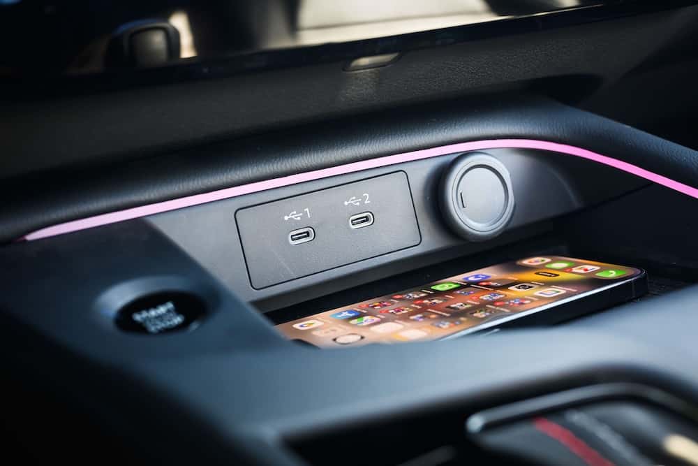 2027 Nissan Sentra center console with a smartphone on the Qi2 wireless charger and USB-C ports