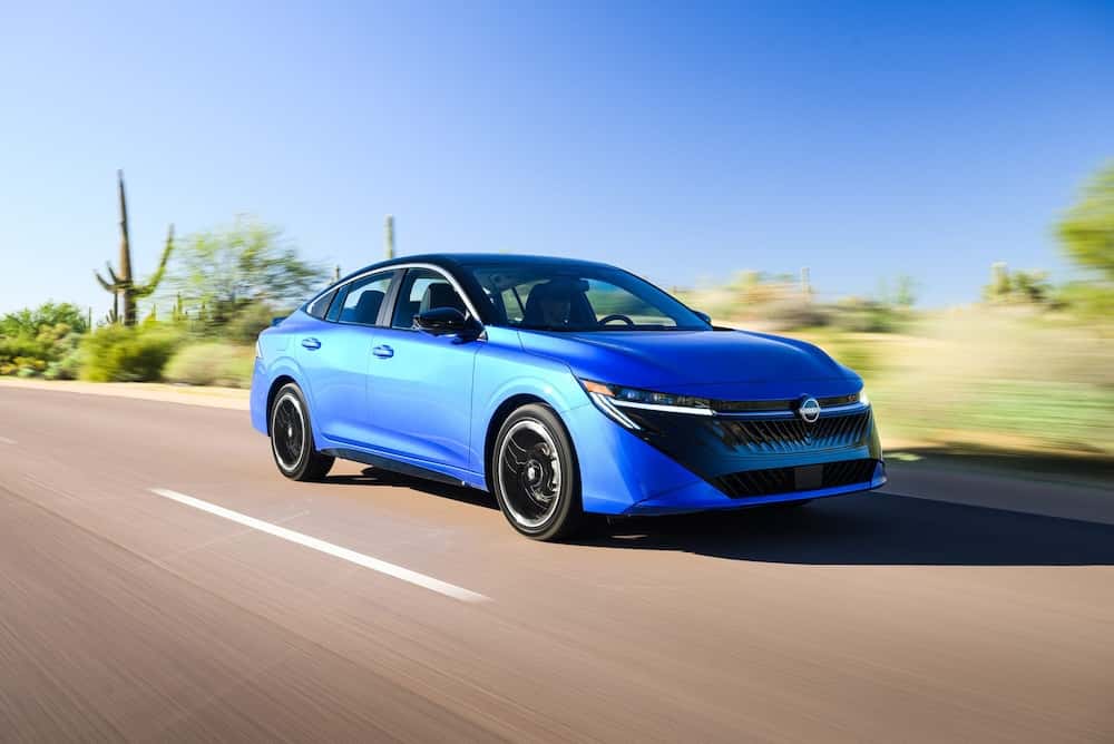 Blue 2027 Nissan Sentra SR driving on a desert highway