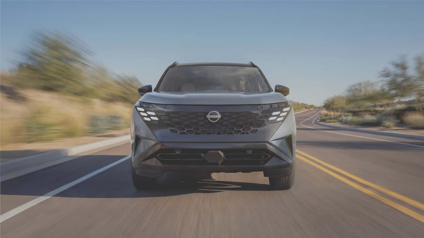2027 Nissan Rogue Hybrid front view showing its two-three running lamp signature and hexagonal grille pattern