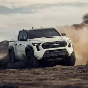 2025 Toyota Tacoma White Front View Driving Off Road through Dirt