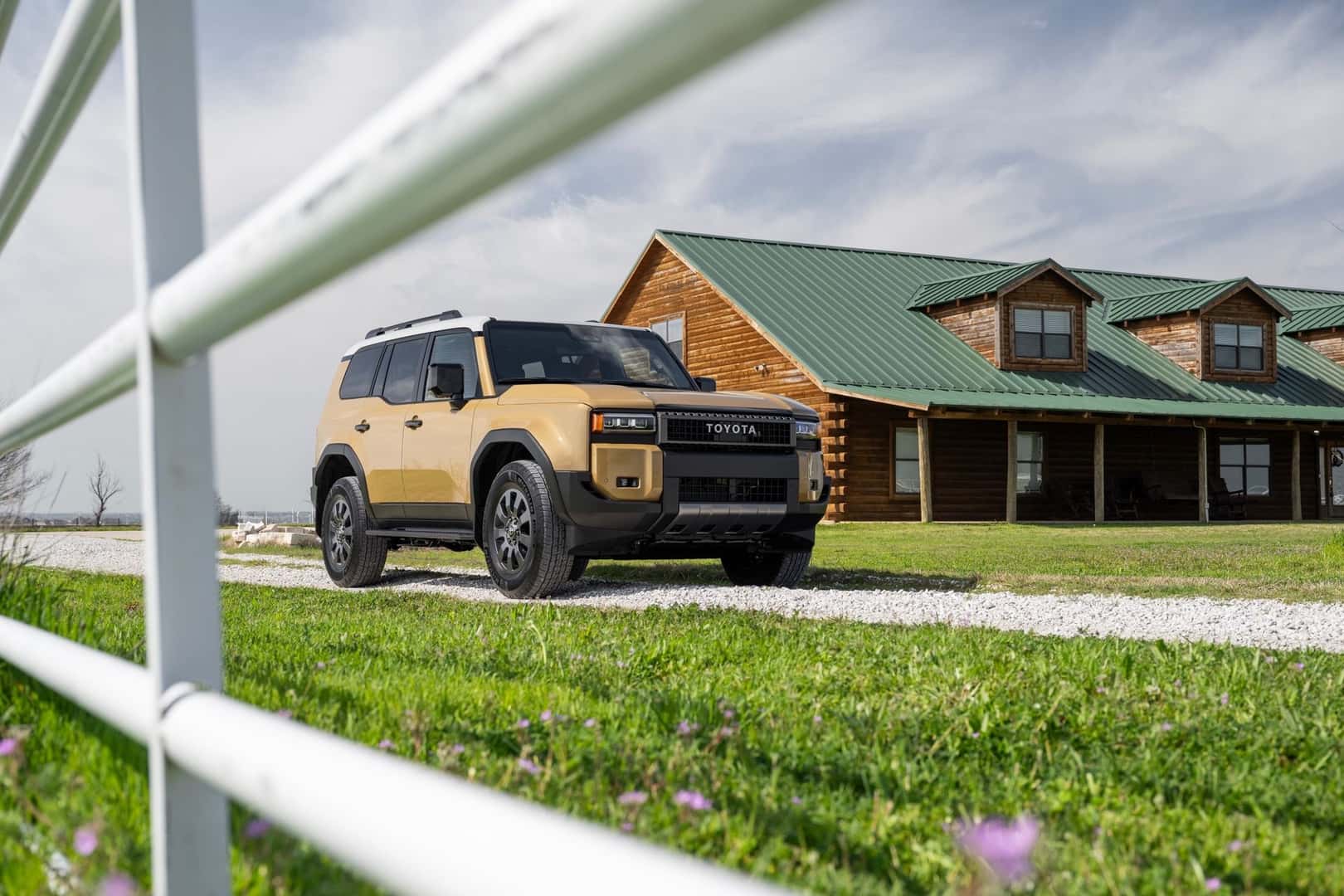 The Tax Breaker And Financial Success: The 2025 Toyota Landcruiser, Parked Out A Long Log House With Green Roofing