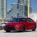 2026 Toyota Camry SE Supersonic Red in a city