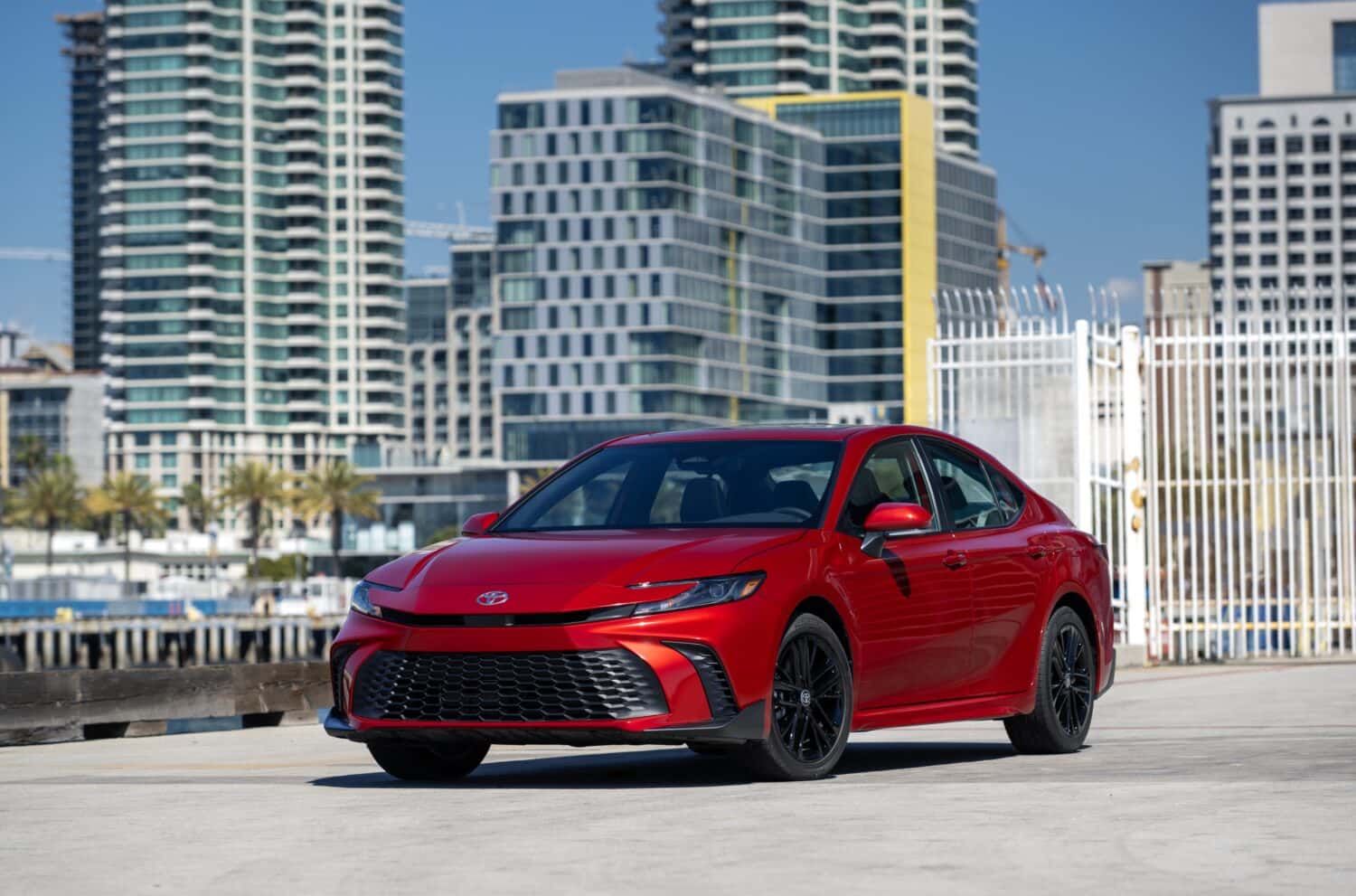 2026 Toyota Camry SE Supersonic Red in a city