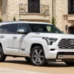 A Powerful And Intimidating 2026 Toyota Sequoia Wind Chill Pearl Trim, Parked Outside An Expensive & Fancy Building