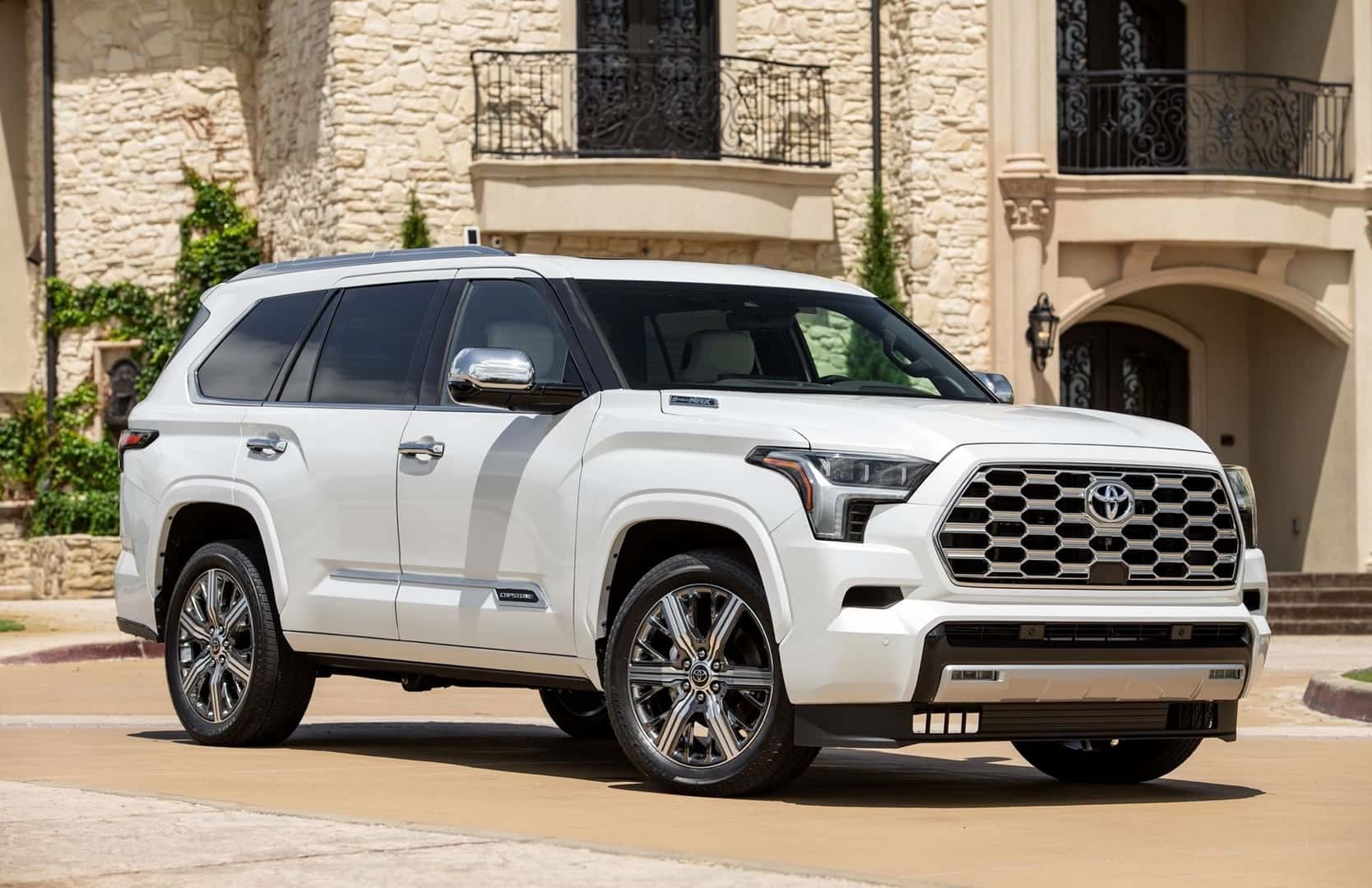 A Powerful And Intimidating 2026 Toyota Sequoia Wind Chill Pearl Trim, Parked Outside An Expensive & Fancy Building