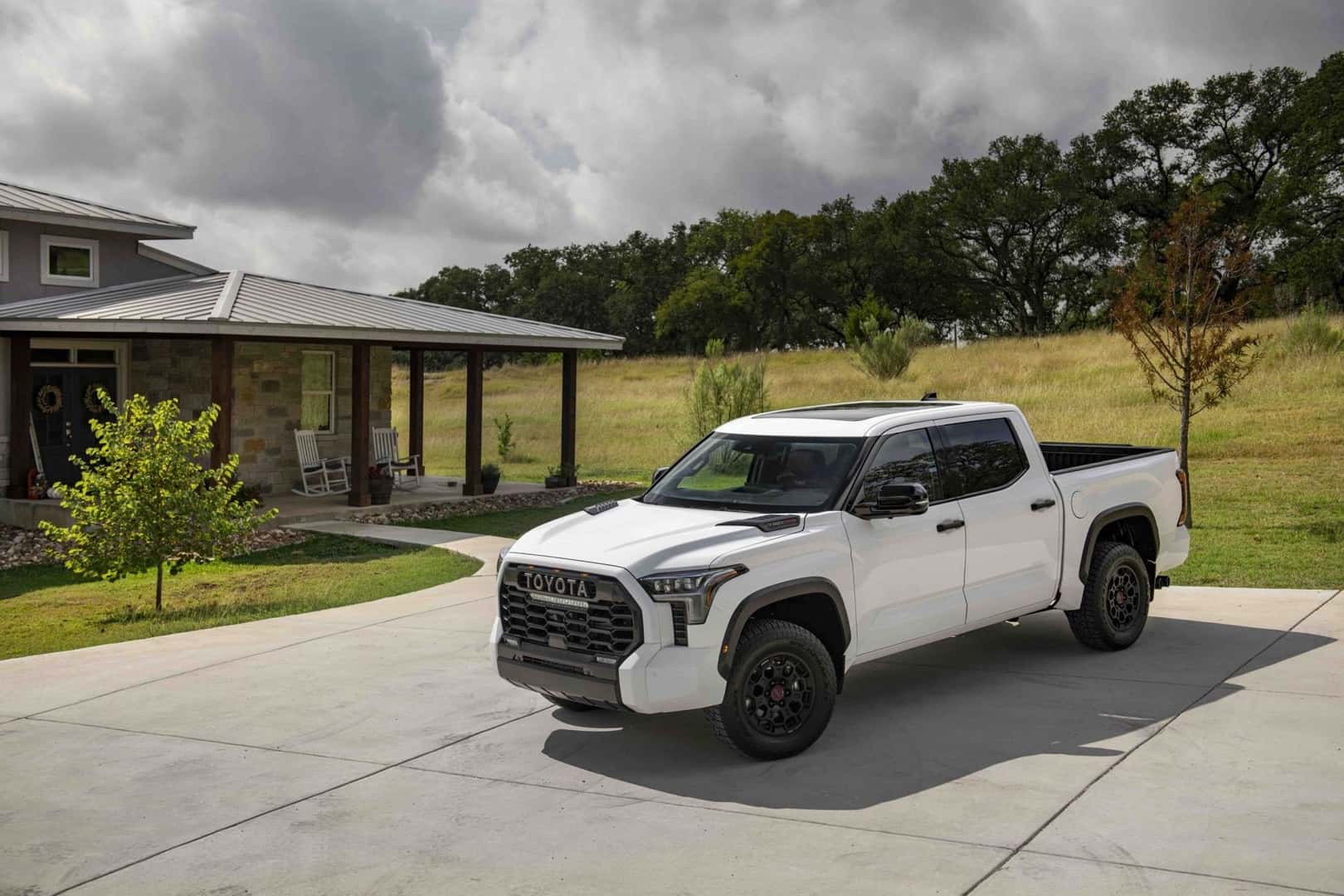 The Tax Deductible 2026 Toyota Tundra TRD Pro, Parked Outside A Quaint House, Near Calm Green Nature