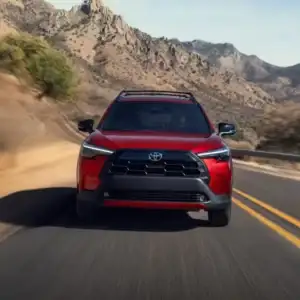 2026 Toyota Corolla Cross Soul Red Crystal front view in motion