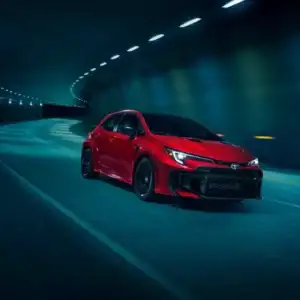2026 Toyota GR Corolla Supersonic Red driving through tunnel