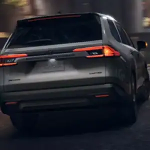 2026 Toyota Grand Highlander Cement rear view in motion
