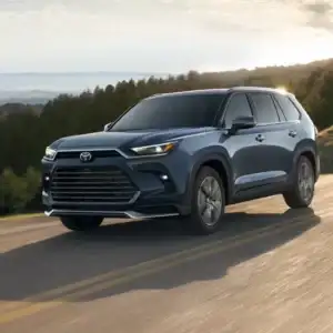 2026 Toyota Grand Highlander Platinum driving with mountain view