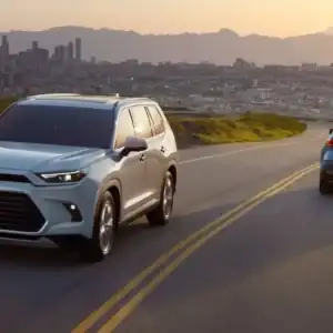 2026 Toyota Grand Highlander Platinum Wind Chill Pearl next to Hybrid