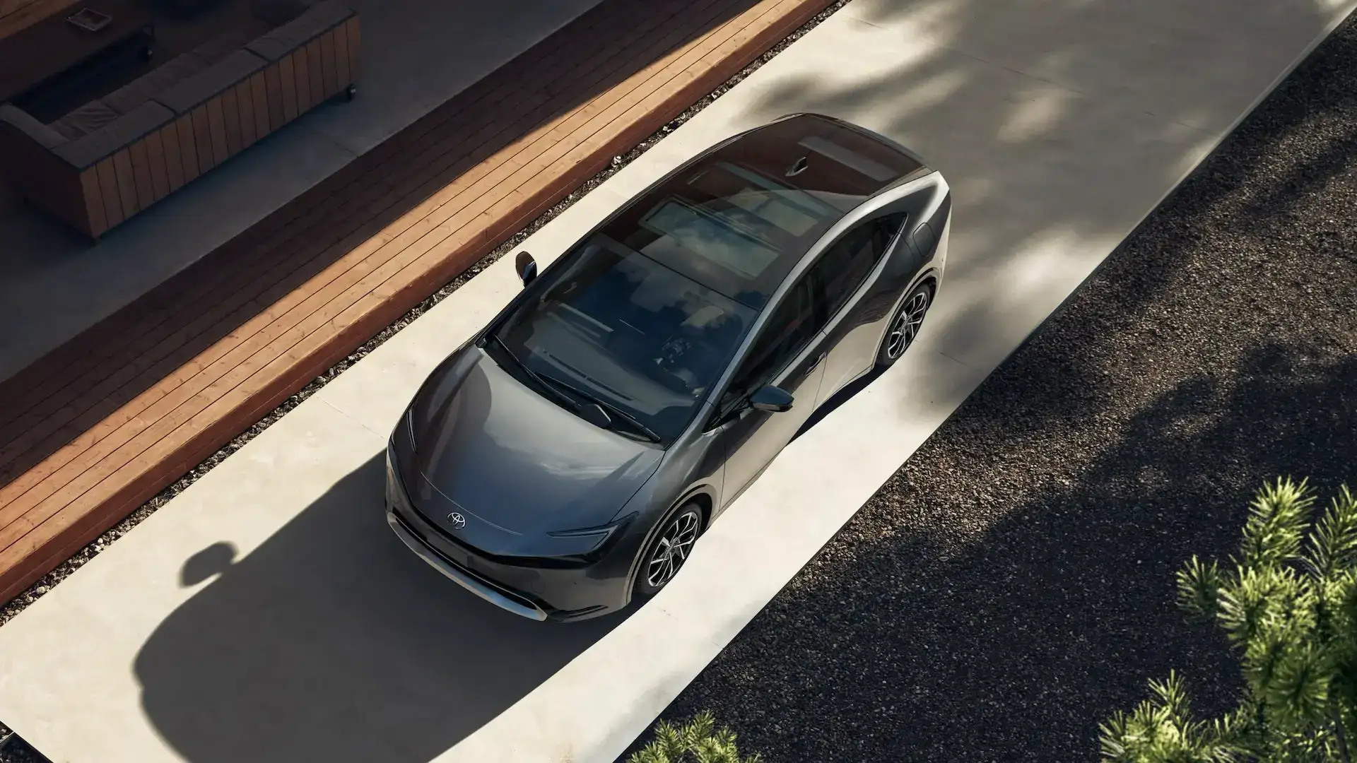View from the top of a 2026 Prius PHEV parked with a planter and gravel in landscaping in view