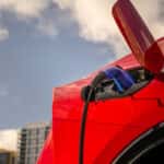 2026 Toyota Prius PHEV Supersonic Red charging