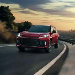 2026 Toyota RAV4 PHEV Supersonic Red with black roof driving