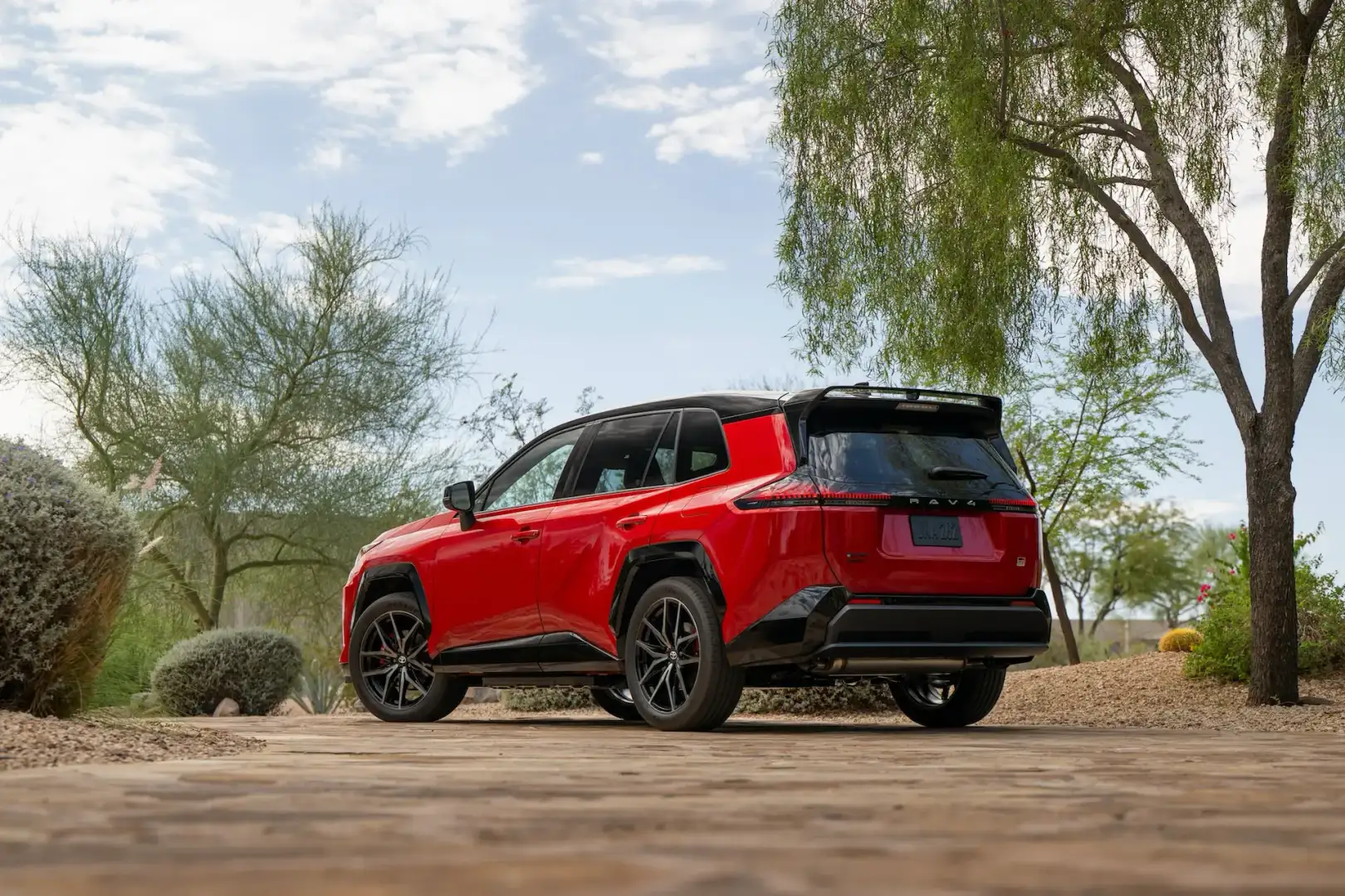 Red 2026 Toyota Rav4 GR Sport view of the back parked off road