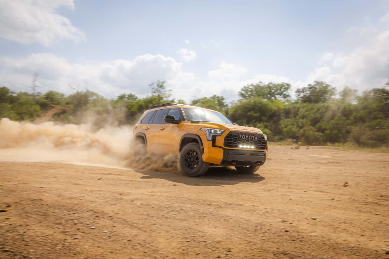 2027 Toyota Sequoia TRD Pro in Honeycomb kicking up dirt on a trail