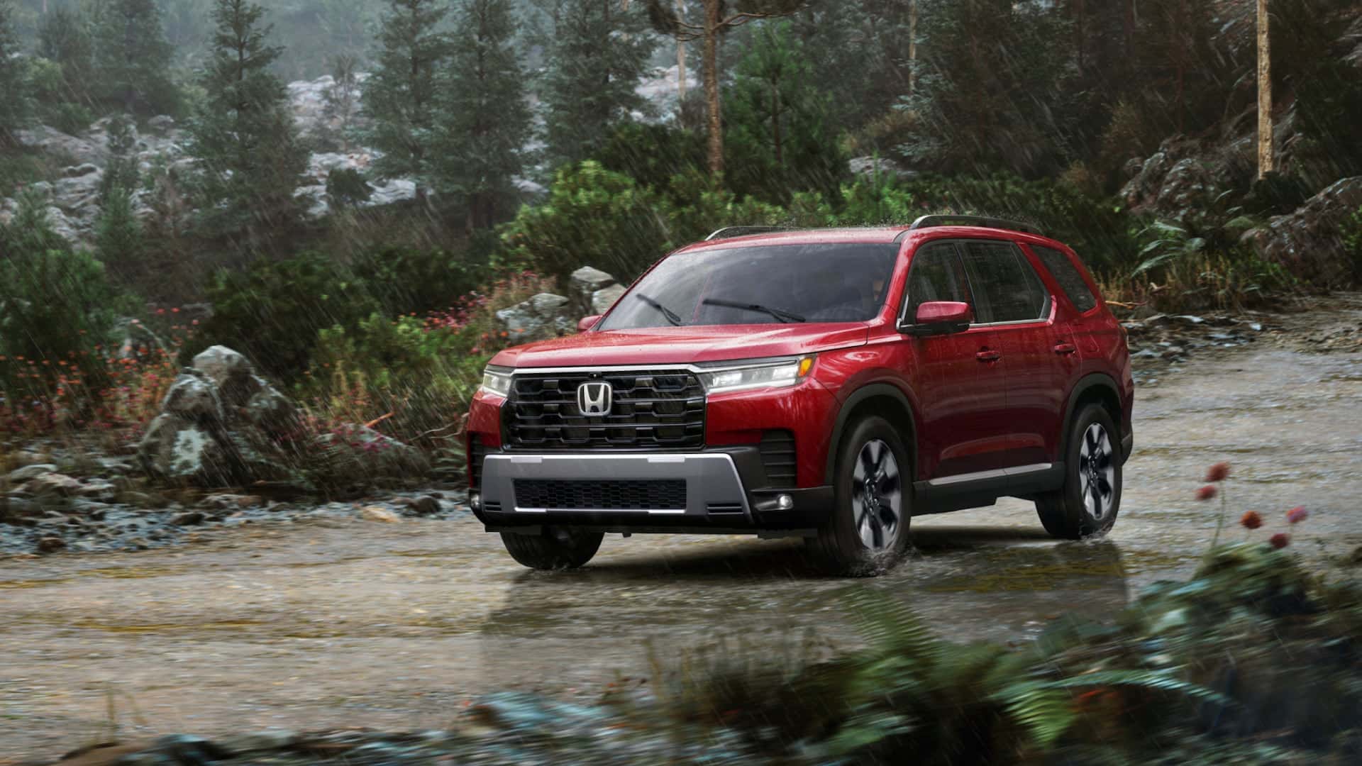A red Honda Pilot driving through rain off-road