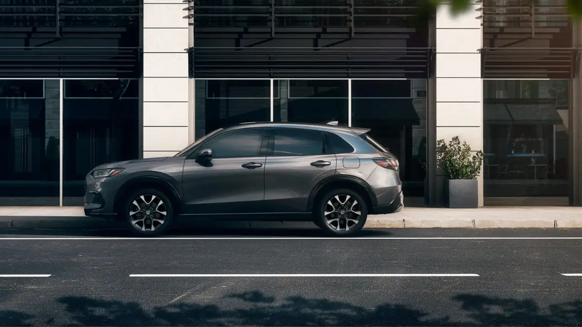 A gray Honda HR-V in profile, parked by the curb in a city