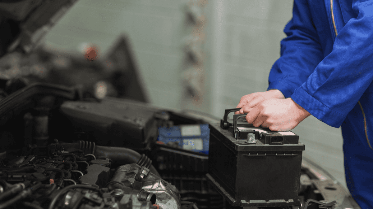 A mechanic replacing a car's battery