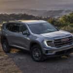A silver 2025 GMC Acadia Elevation parked off-road