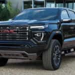 Black 2026 GMC Canyon parked off-road on gravel