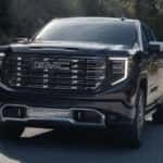 Black 2026 GMC Sierra 1500 for sale near Champaign rounding a corner on a test drive
