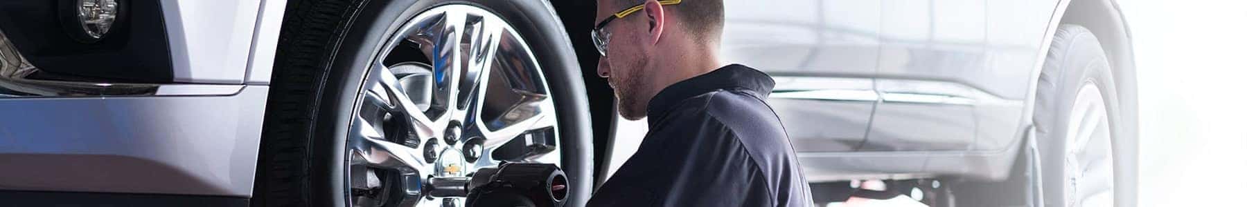 Chevrolet technician rotating tires on a vehicle