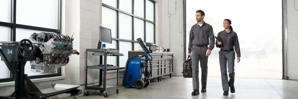 2 GM technicians walking in a service bay