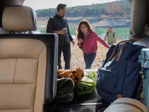 2024 Chevrolet Equinox view of family with back of vehicle open and supplies in cargo area