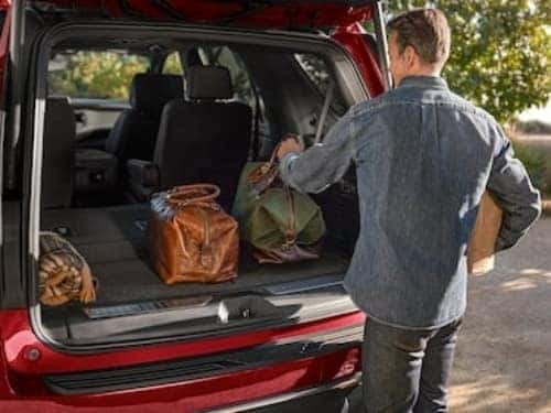 2024 Chevrolet Tahoe view of man loading bags into the cargo area