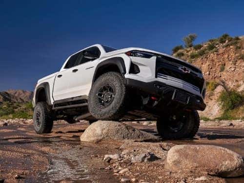 2024 Chevrolet Colorado driving over large rocks