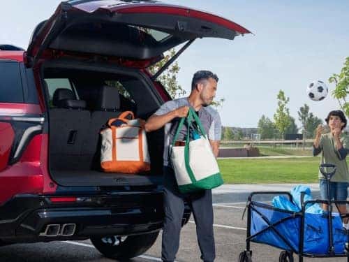 2025 Chevrolet Traverse view of man unloading bags from cargo area