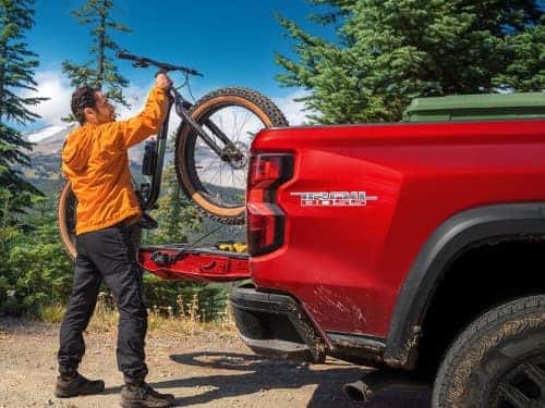 2025 Chevrolet Colorado view of man loading a bike into the bed