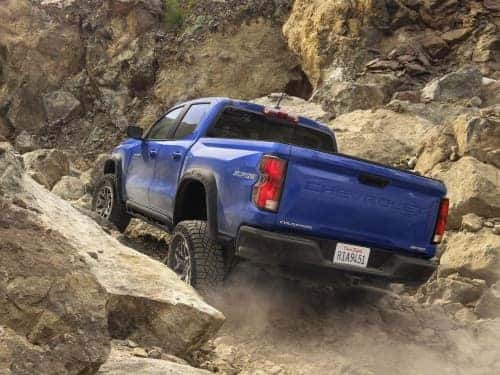 2025 Chevrolet Colorado driving up a rocky terrain