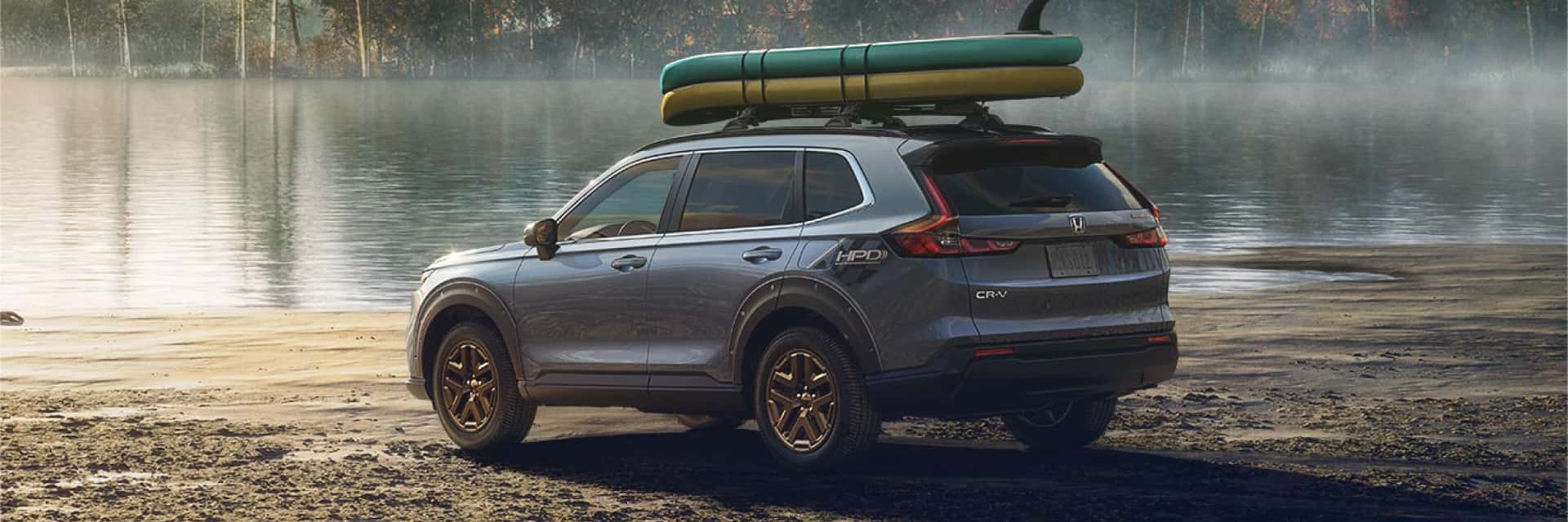 2024-electric-honda-cr-v-hybrid-parked-by-foggy-swamp-with-kayaks-stapped-on-top