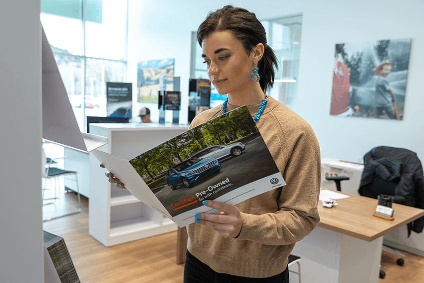 woman looking at VW catalogue