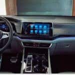 Interior dashboard view of a 2026 Volkswagen Atlas showing the steering wheel and touchscreen display.