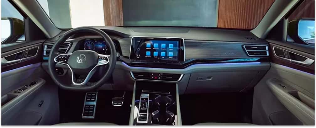 Interior dashboard view of a 2026 Volkswagen Atlas showing the steering wheel and touchscreen display.