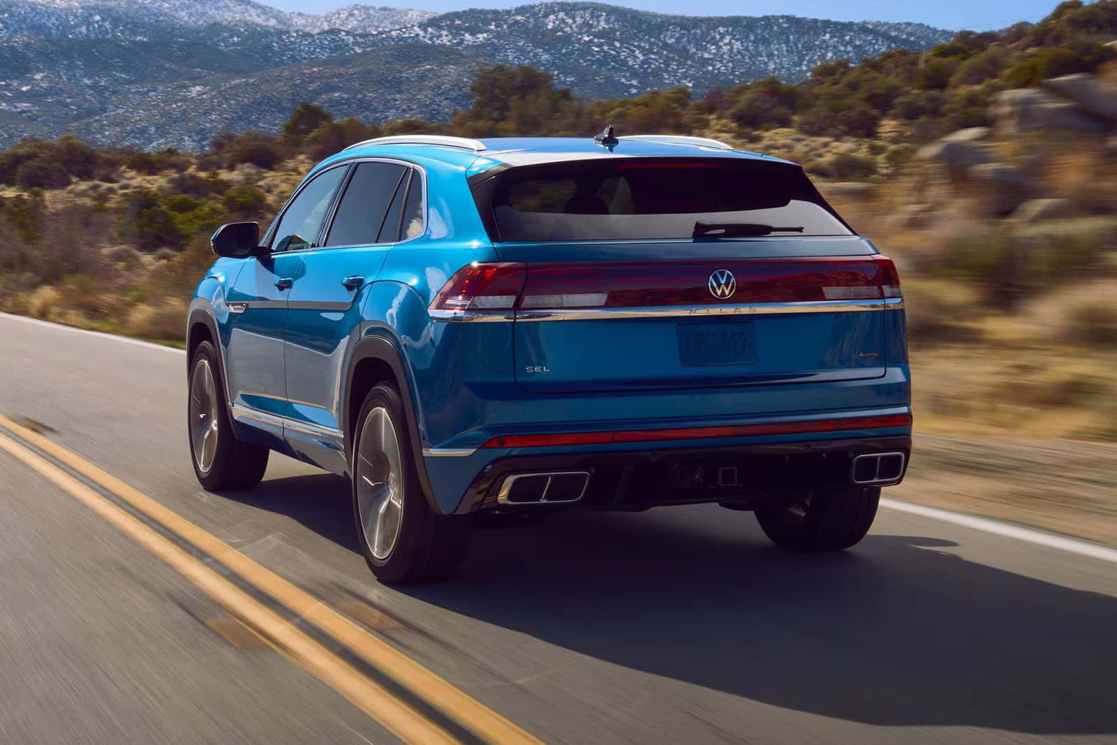 2026 Volkswagen Atlas Cross Sport driving down a street