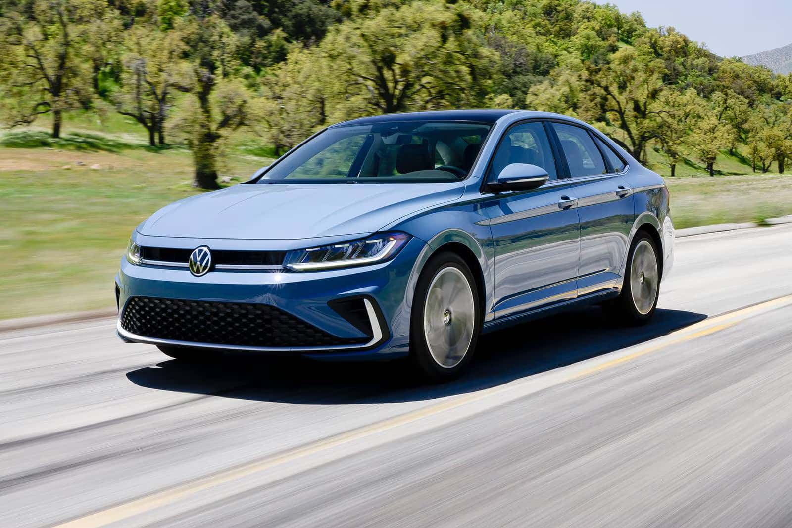 2026 Volkswagen Jetta driving next to a forest