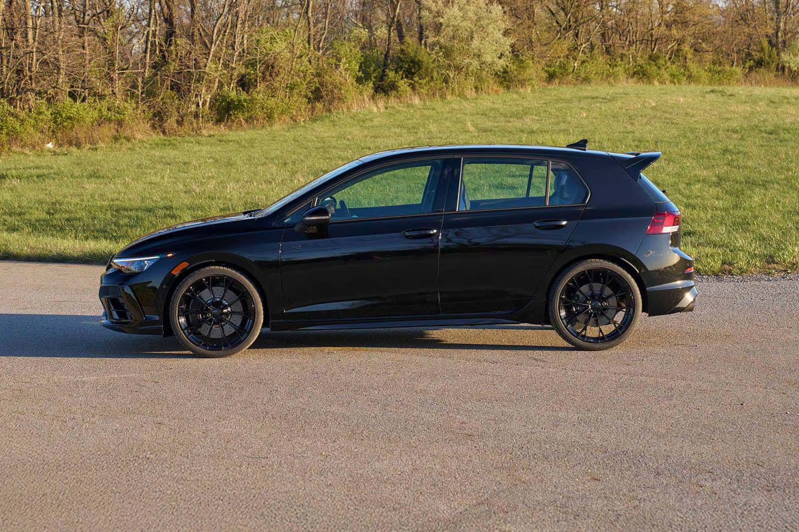 the new 2026 volkswagen golf r parked next to a field